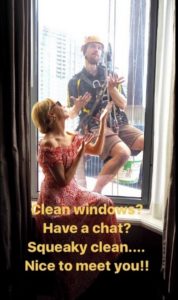 Kylie Minogue photobombed by window cleaner